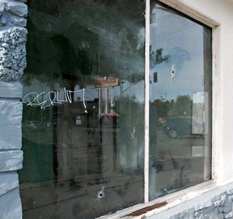 ChildsNext door bullet holes highland park and brenda rees.jpg